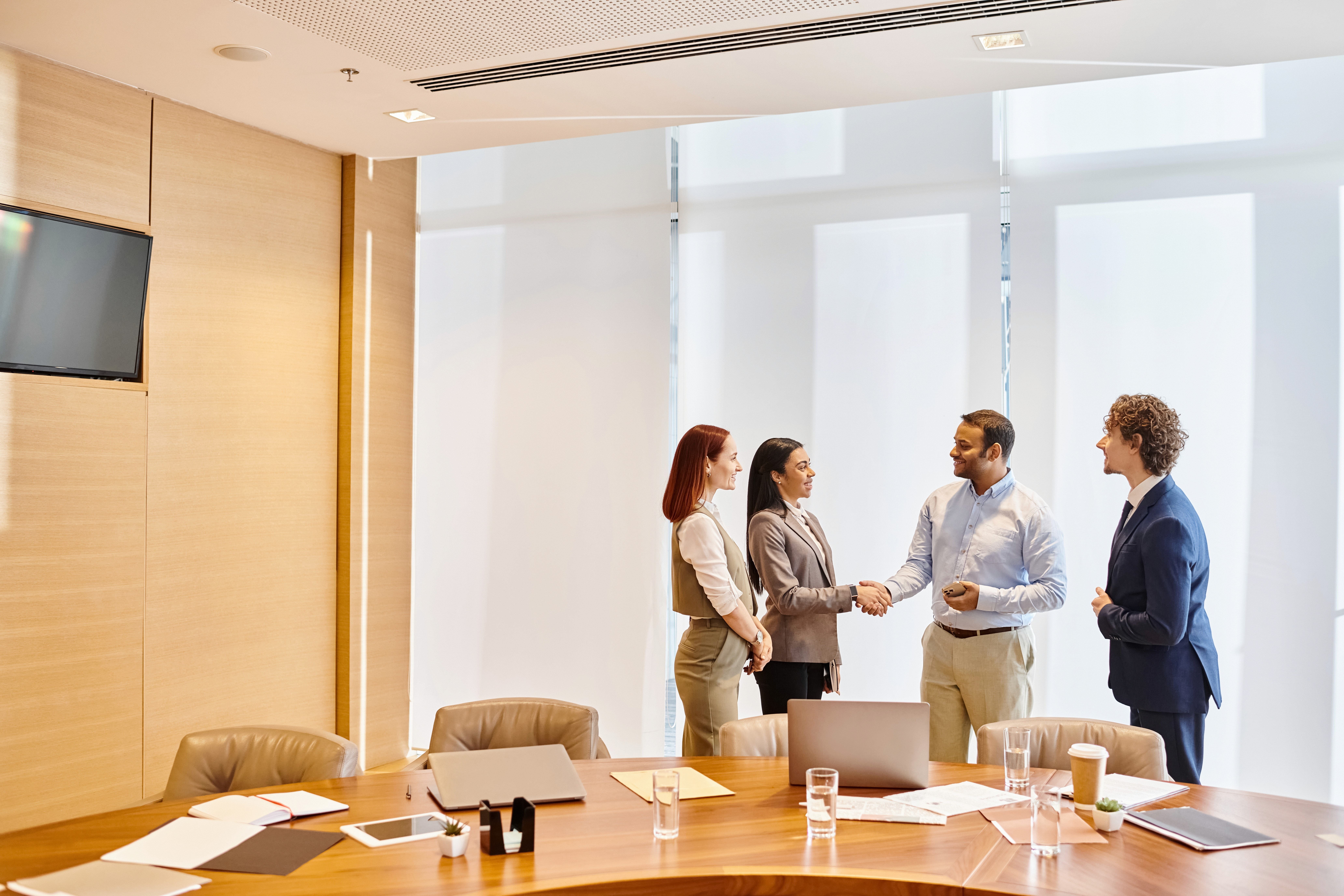 Image of a team of diverse attorneys in a modern conference room.