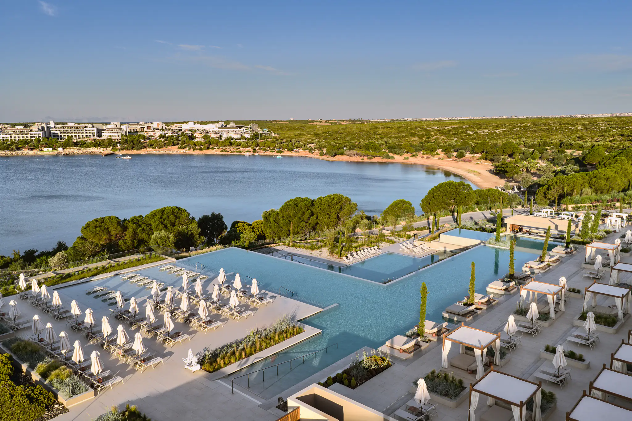 Aerial view of the pool and sunbed areas beside the bay