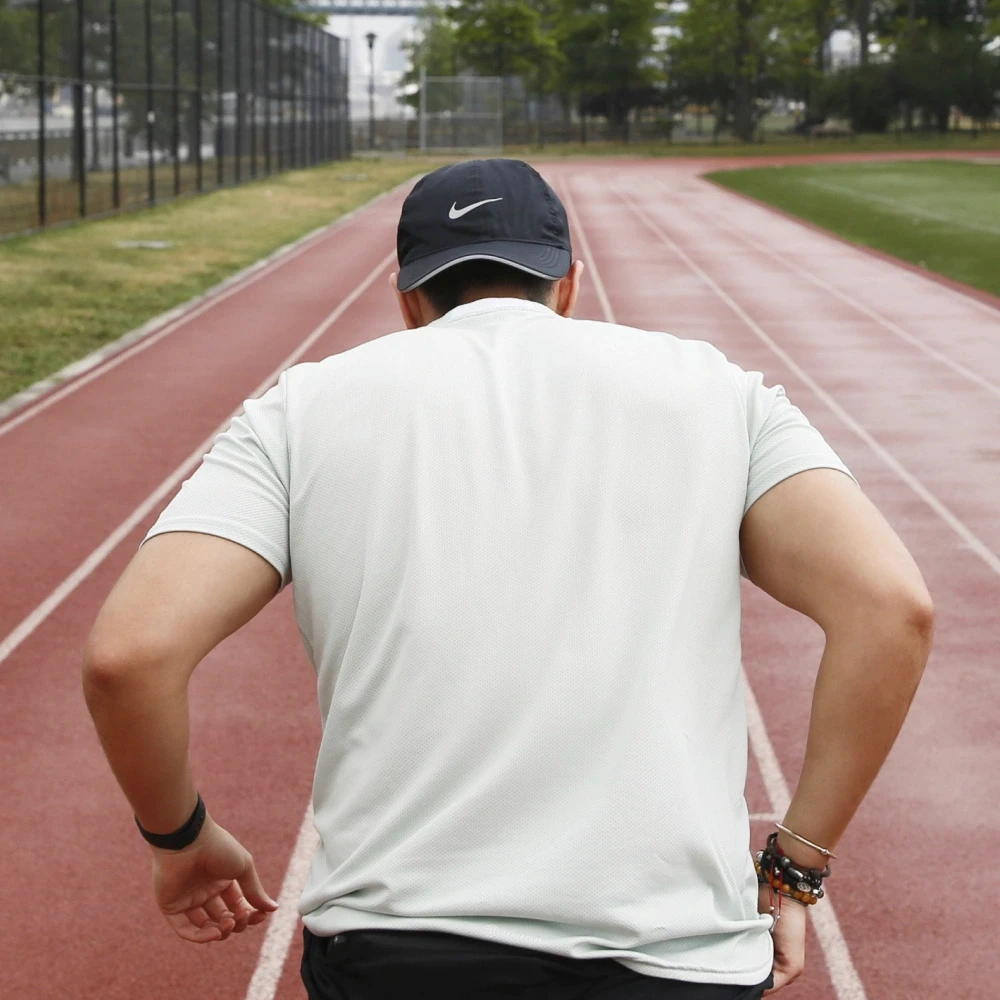 Man setting off a run on track