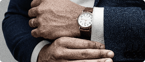 man in blue suit jacket wearing gold round analog watch