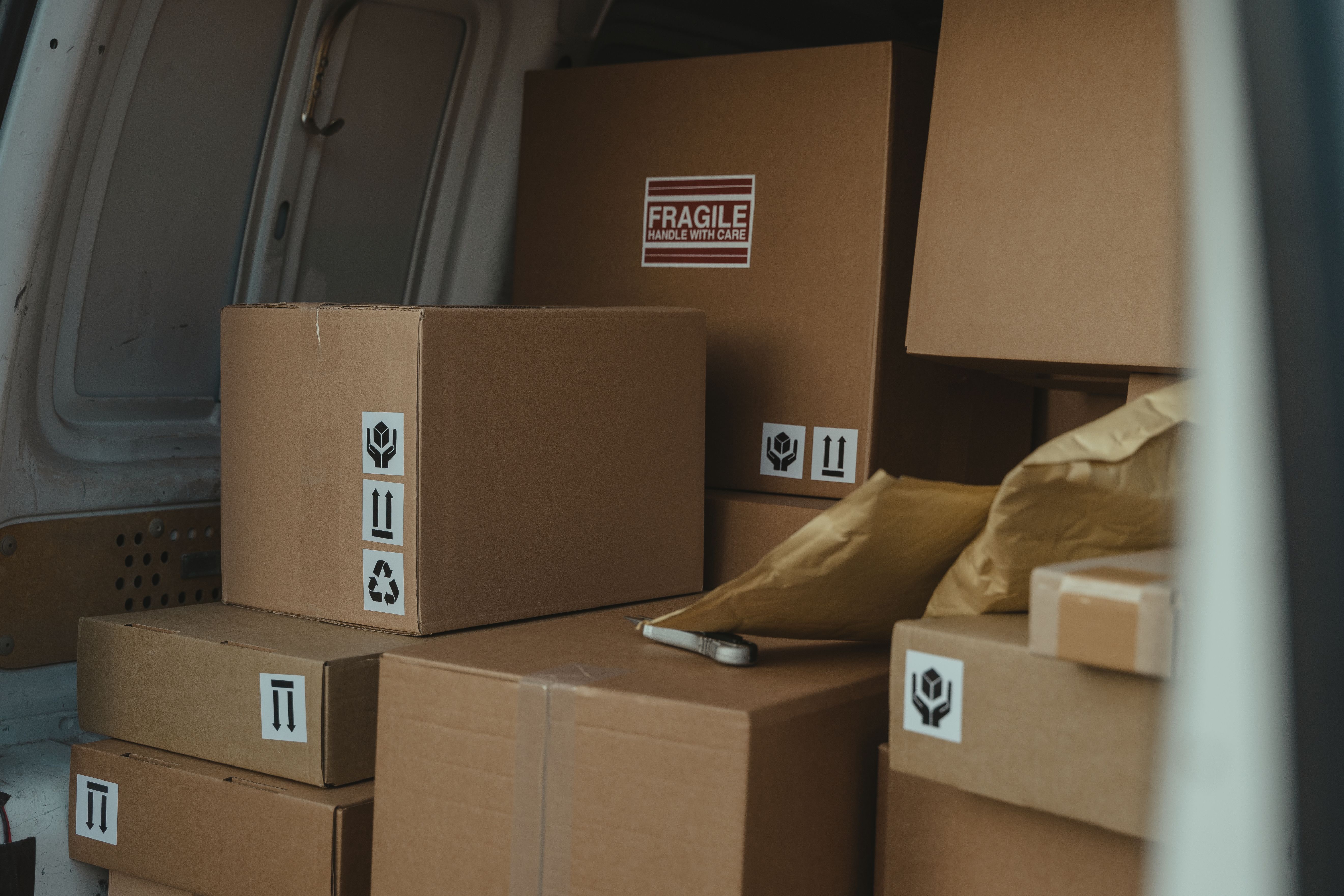 A delivery truck full of carton shipping boxes.
