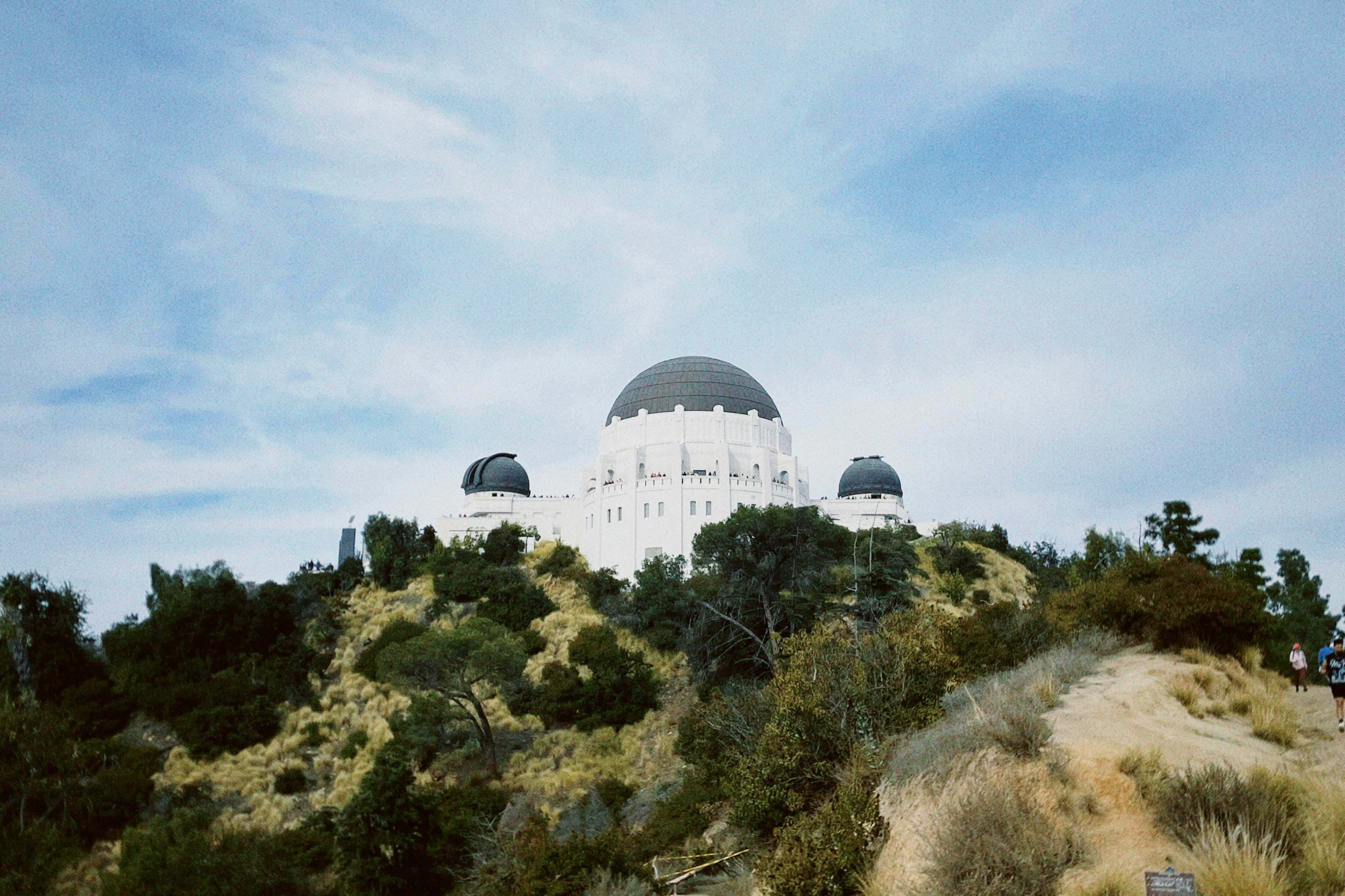 a large white building on top of a hill