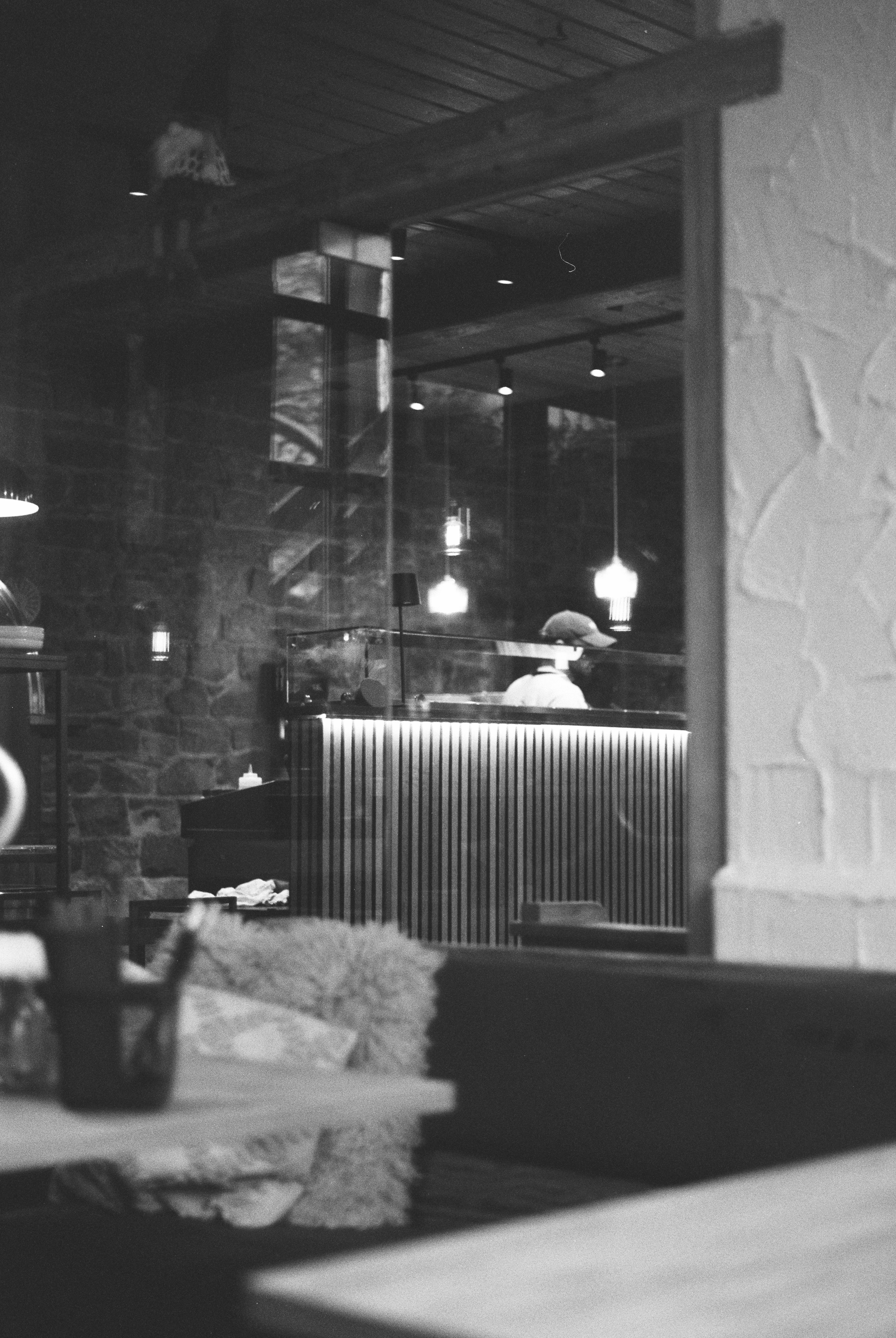 Interior of a dimly lit restaurant with a bar