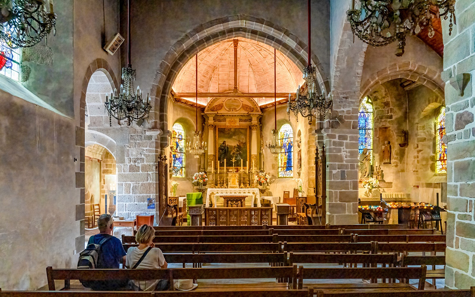 Interior of Church of Saint Pierre with altar and stained glass, Mont Saint Michel tour.