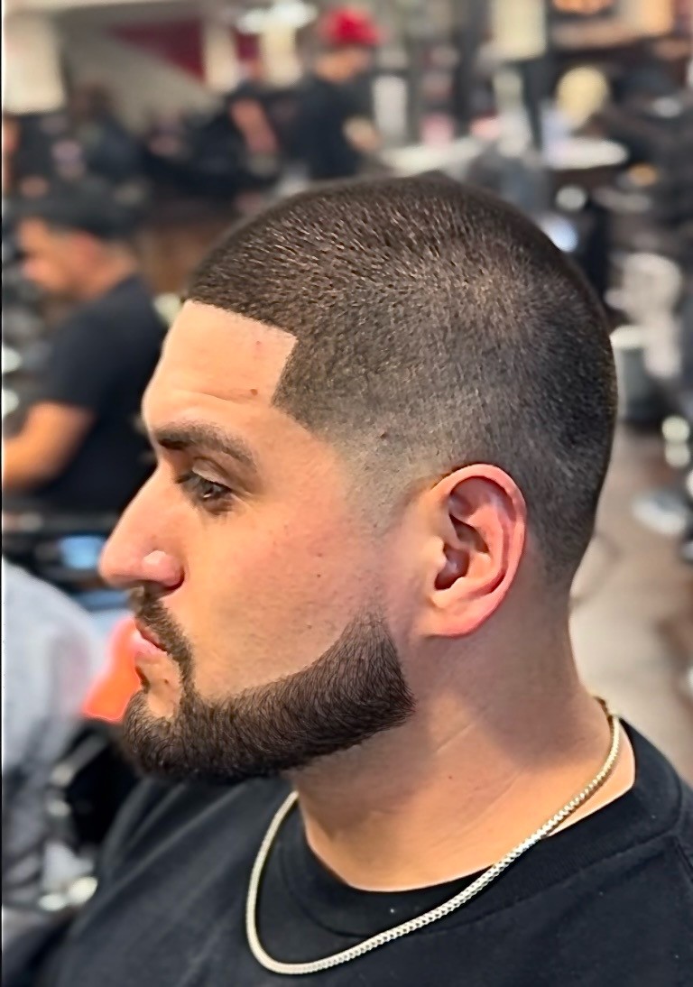 Sharp beard lines and profile enhancements paired with a low fade, showcasing precision grooming.