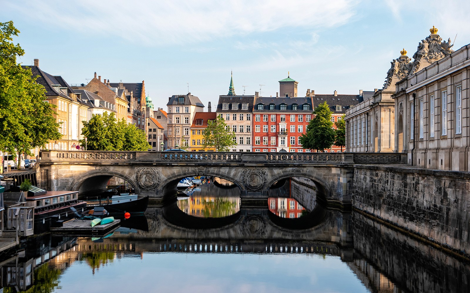 Marmorbroen bridge over canal with colorful buildings in Copenhagen, Denmark.