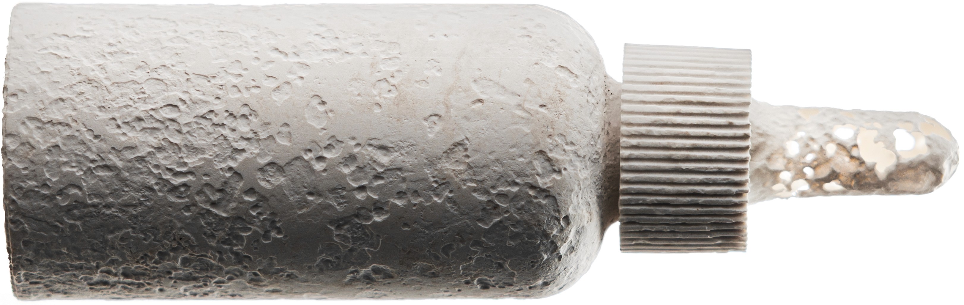 A biodegraded VIVOMER dropper showcasing the rigid bottle, threaded cap, and flexible bulb all returning to nautre together. Winner of the 2025 Pentawards for Sustainable Design, this Shellworks innovation engineers every component from the same plastic-free, home-compostable material, eliminating the multi-material waste typical of skincare packaging and leaving zero microplastics behind.