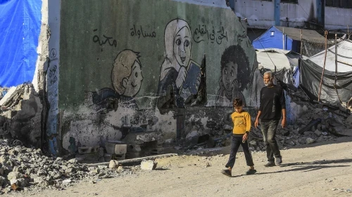 A Palestinian man and boy walk among the rubble of destroyed buildings in Khan Yunis, in the southern Gaza Strip, on Oct. 21, 2025. Photo courtesy of Abed Rahim Khatib/Flash90.