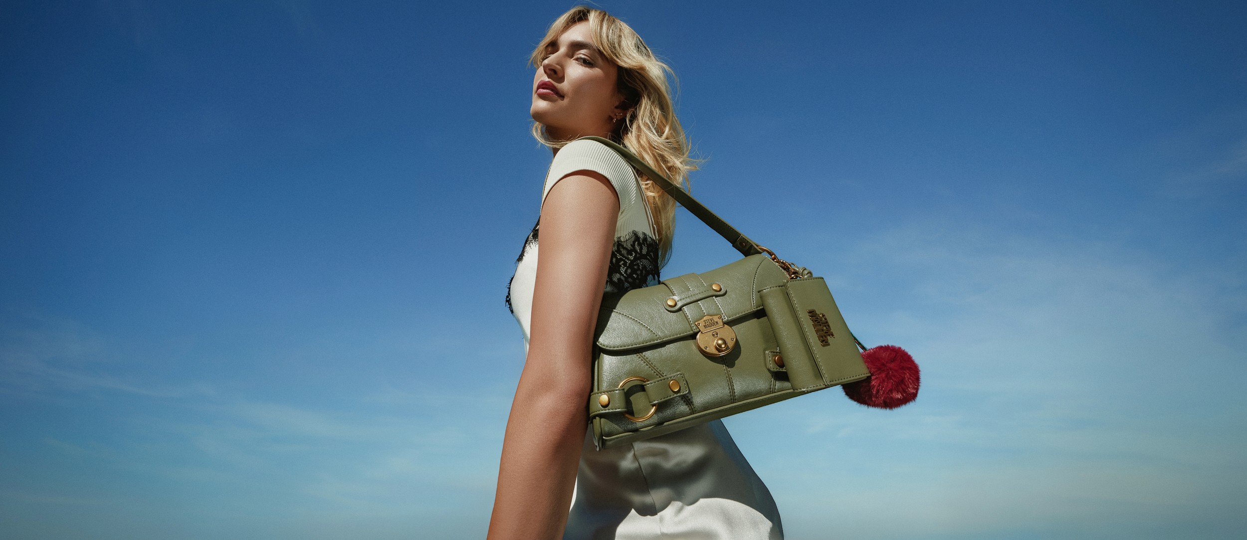 Fashion campaign portrait in red against blue sky