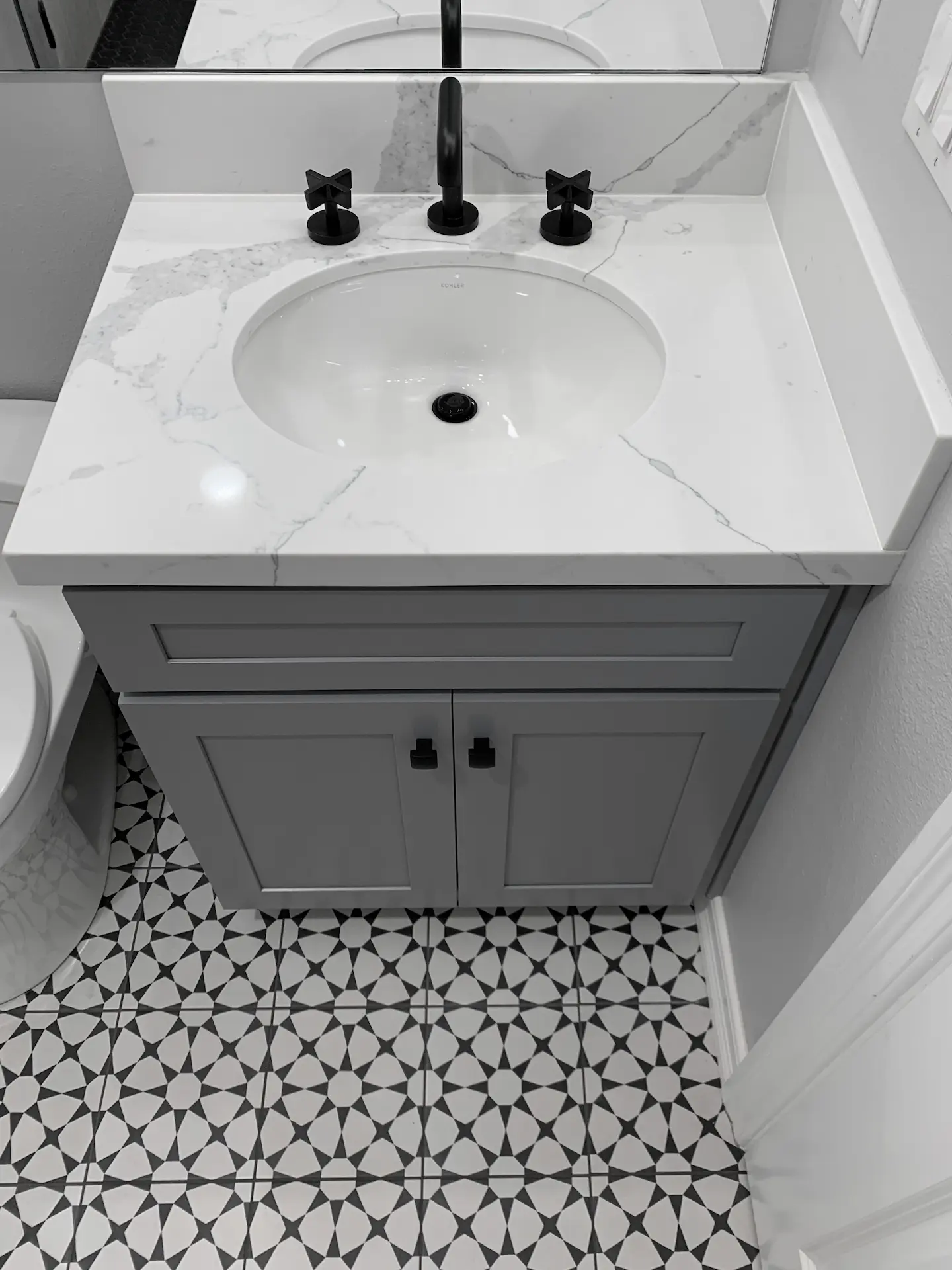 Overhead view of the guest bath vanity, capturing the sleek design and clean lines that define this contemporary bathroom. Photo by Todd Huge.