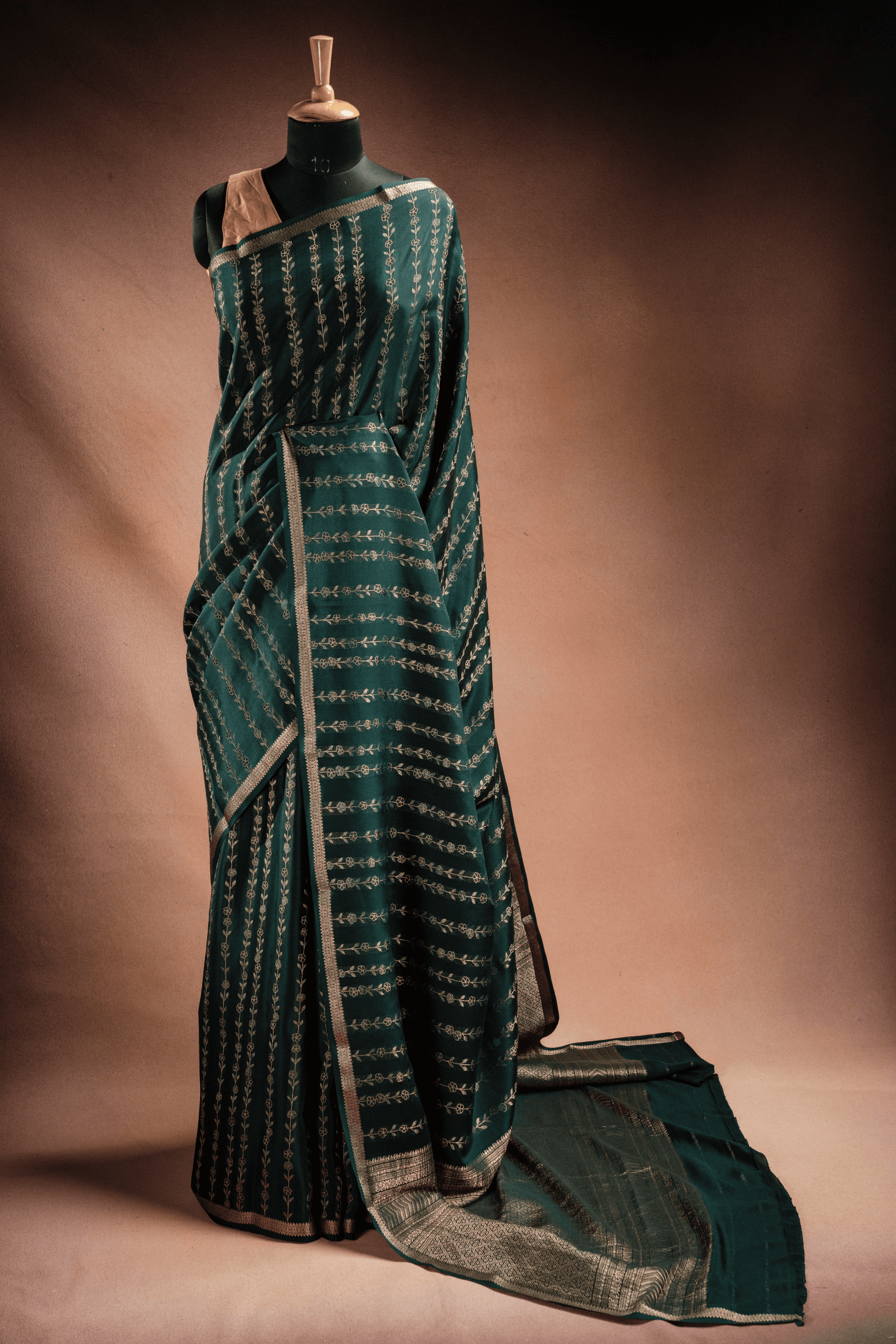 A manequin wearing a pink crepe saree, showcasing its soft drape and elegant, minimalist charm.