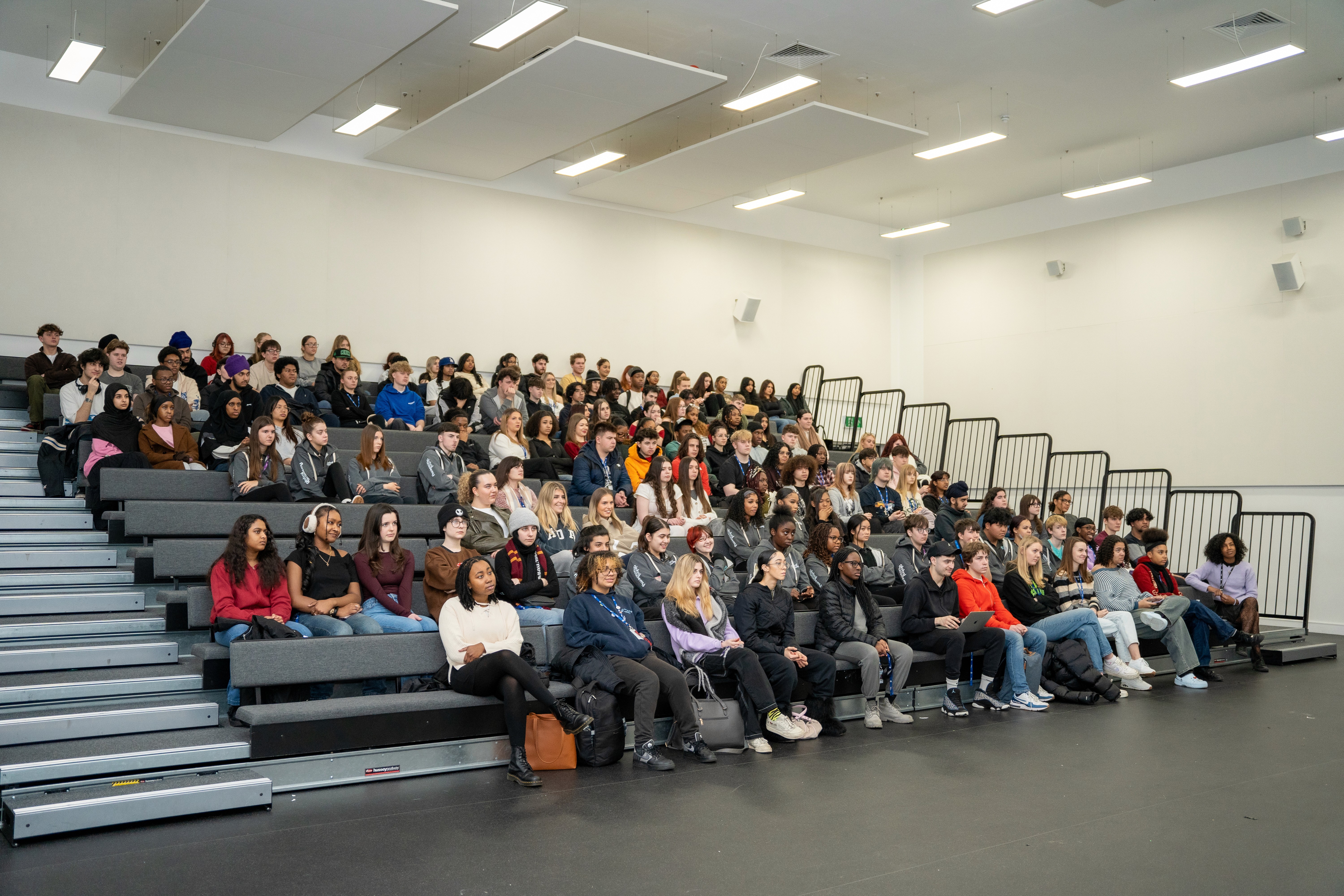 Woman in conical hat rides bicycle down street.