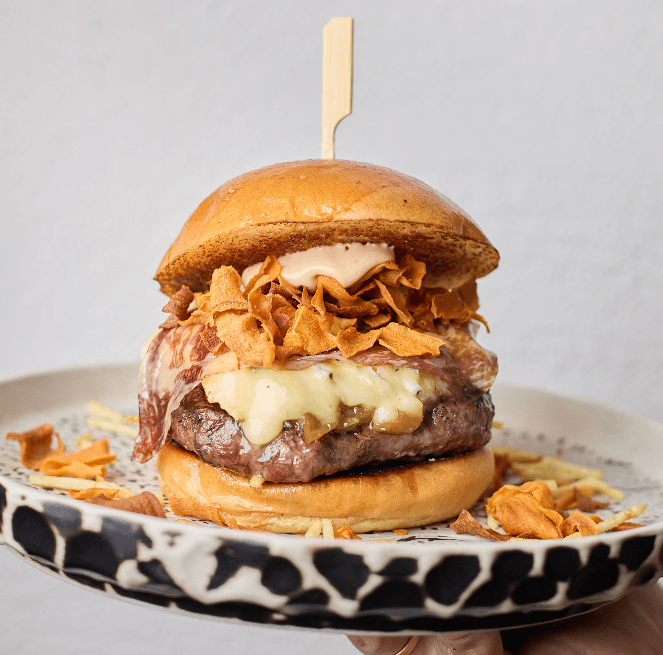 Hamburguesa WagYUM de Hatillo con cecina de wagyu Discarlux, salsa Misoshimi, queso Bavaria Blue y chips de boniato dorados.