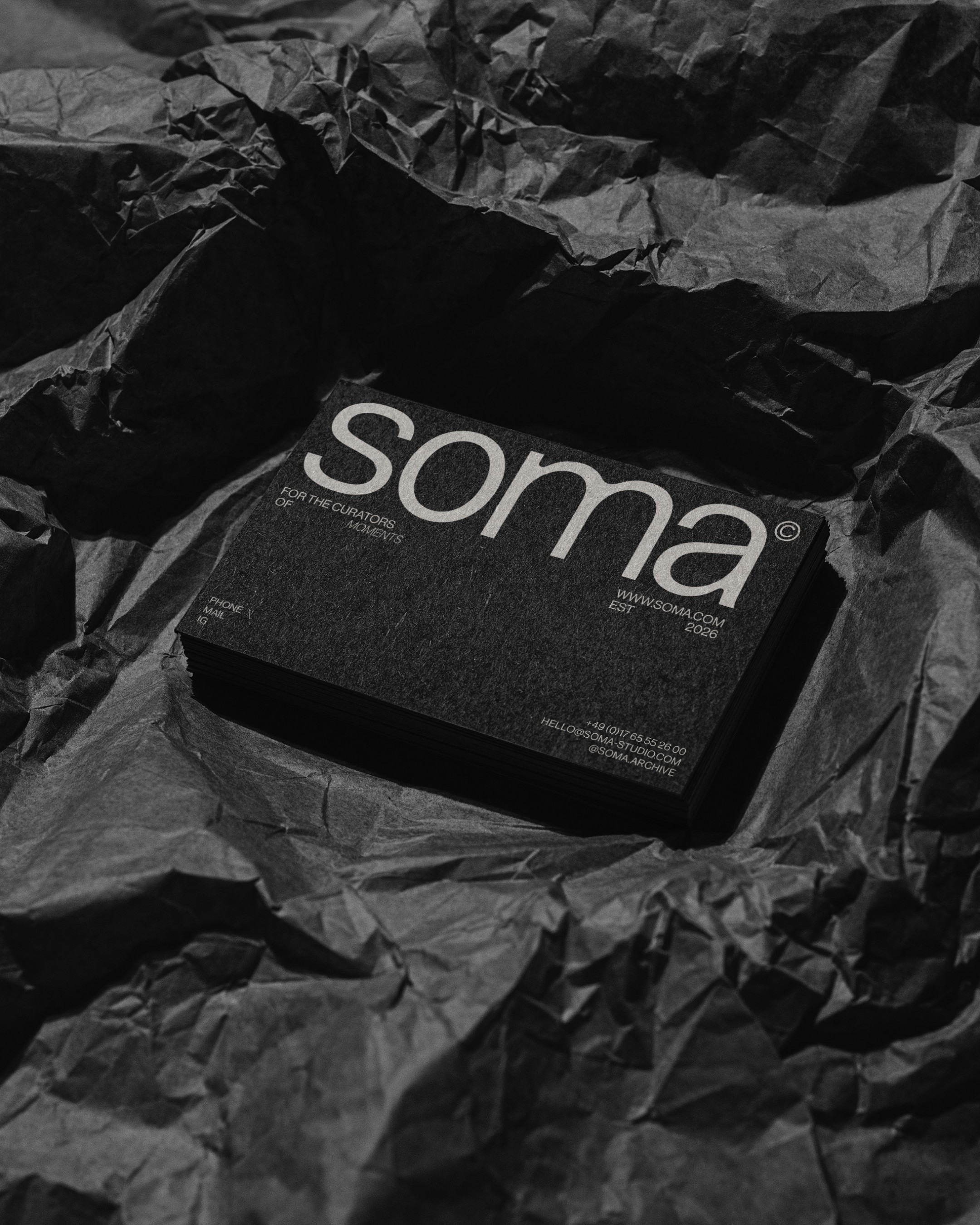 A modern laptop sits on a minimalist gray chair, displaying a website with bold typography reading "forma," showcasing an elegant editorial design layout in a sunlit interior space, reflecting the essence of contemporary brand identity systems and visual identity design for creative entrepreneurs.