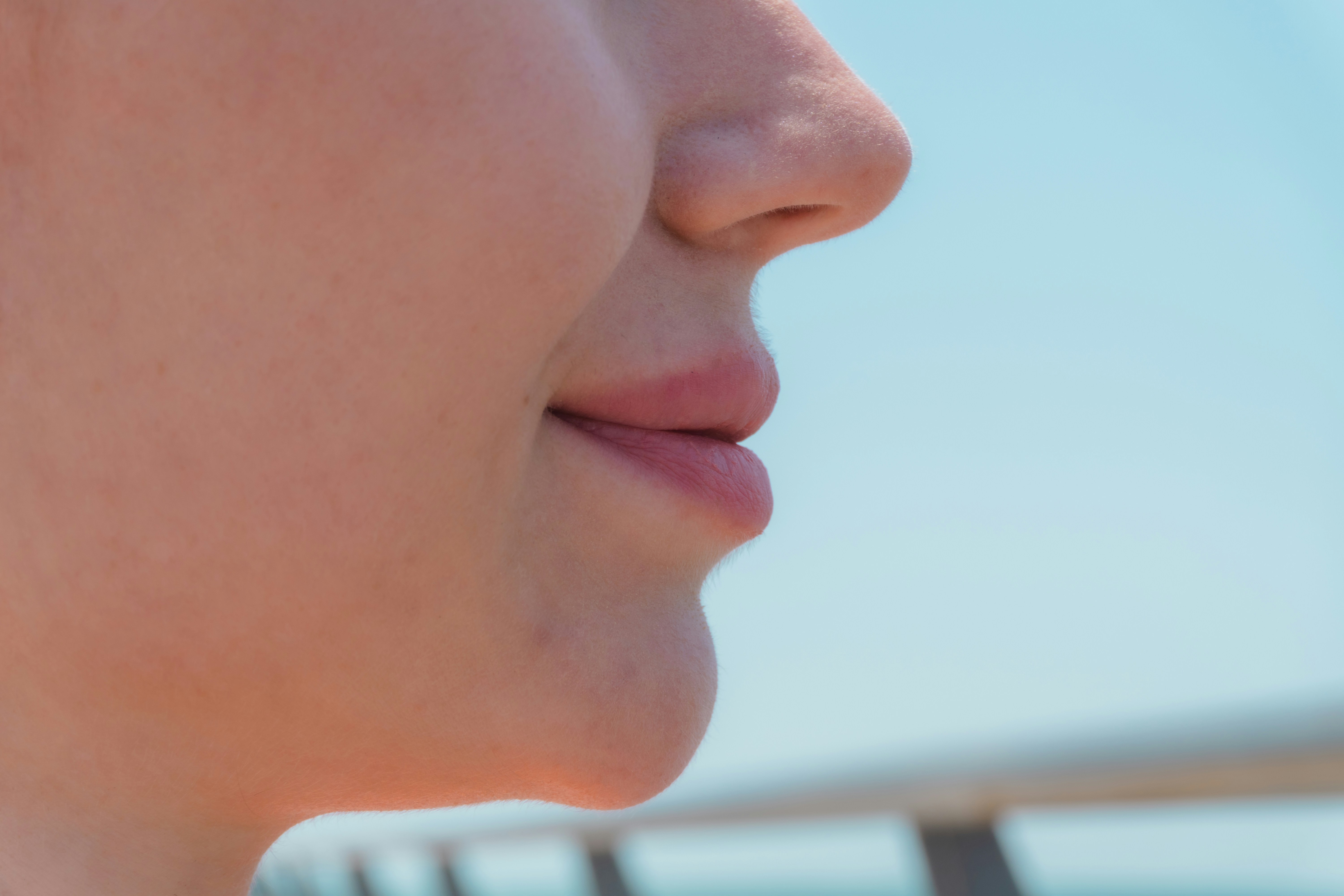 Close-up profile of a young woman's lips