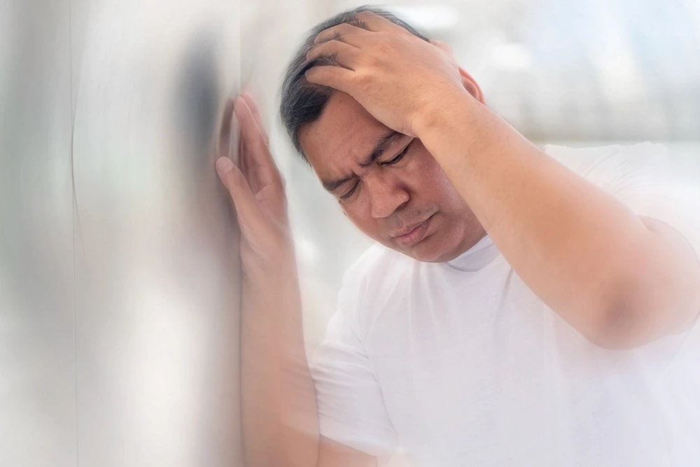Man sitting in a testing booth having a hearing test