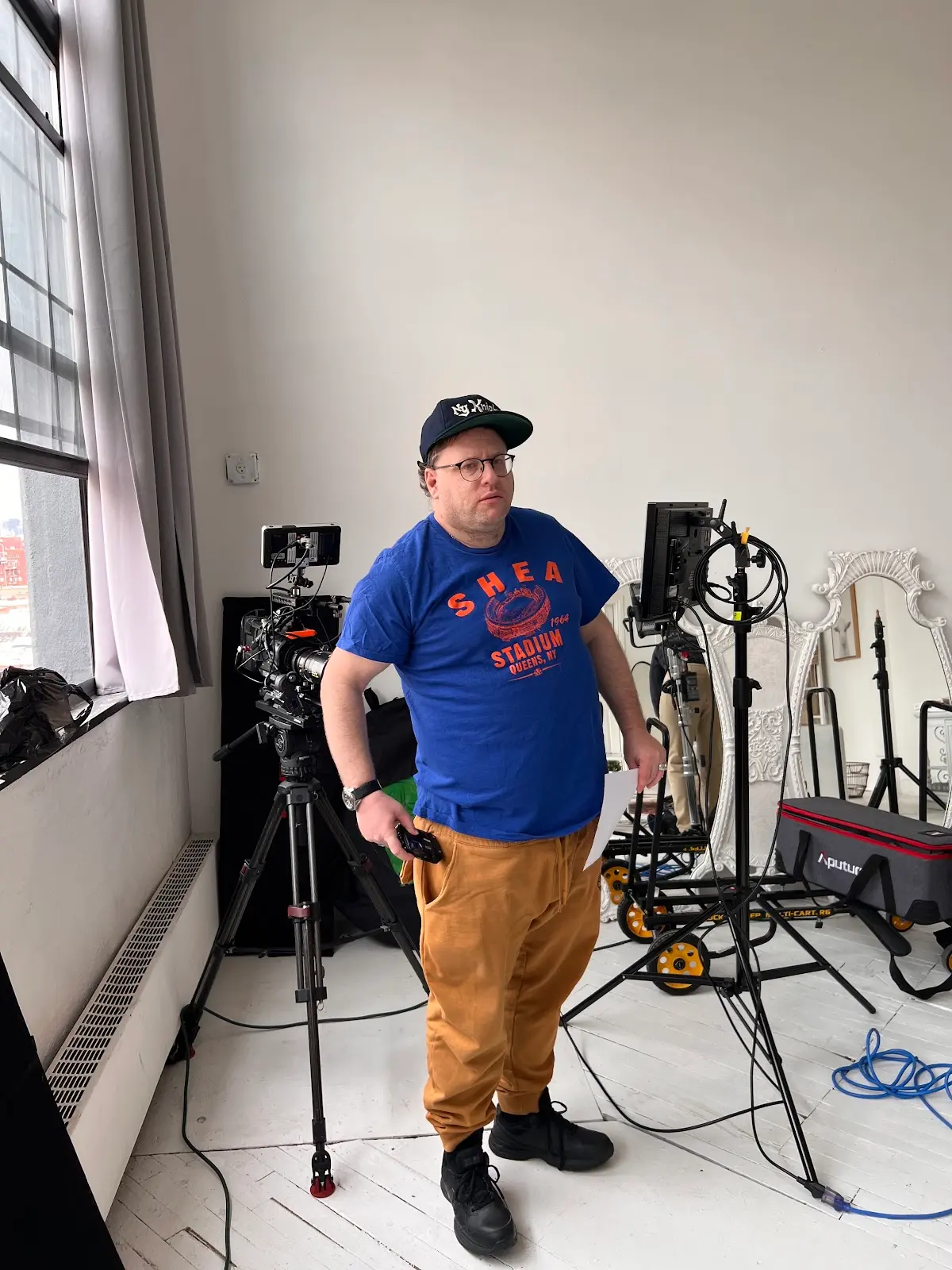 Host on the loft studio set between takes
