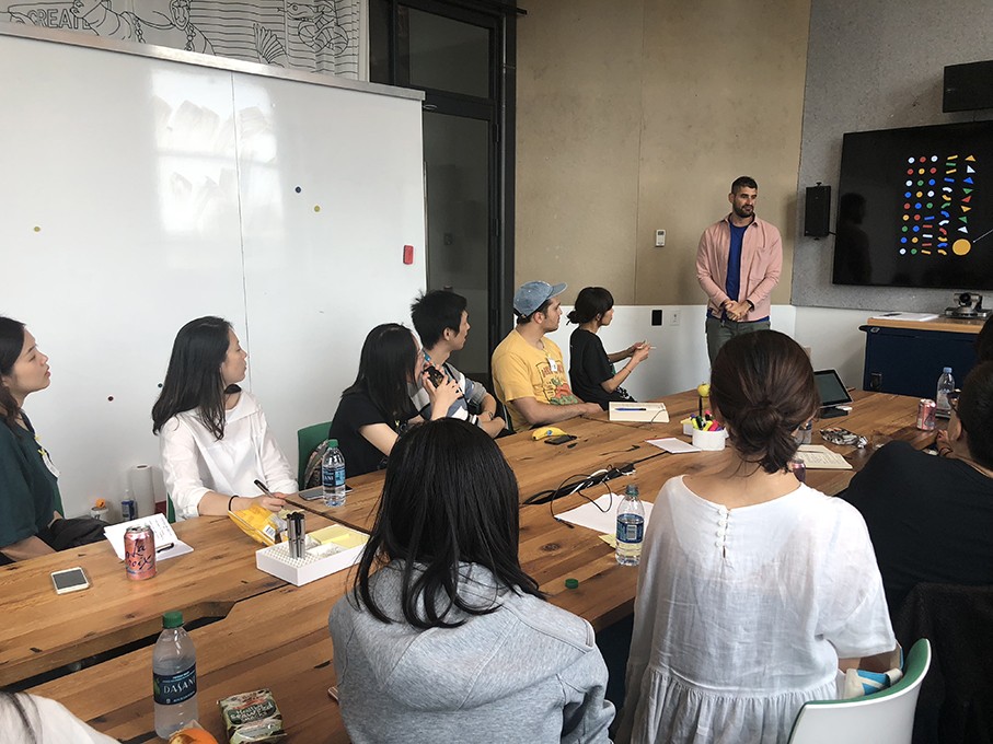 a course class with students and the teacher presenting the design lesson