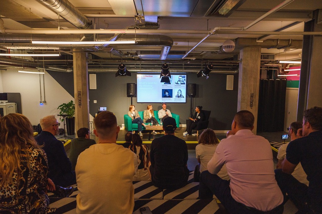Panel discussion event with audience in modern industrial setting