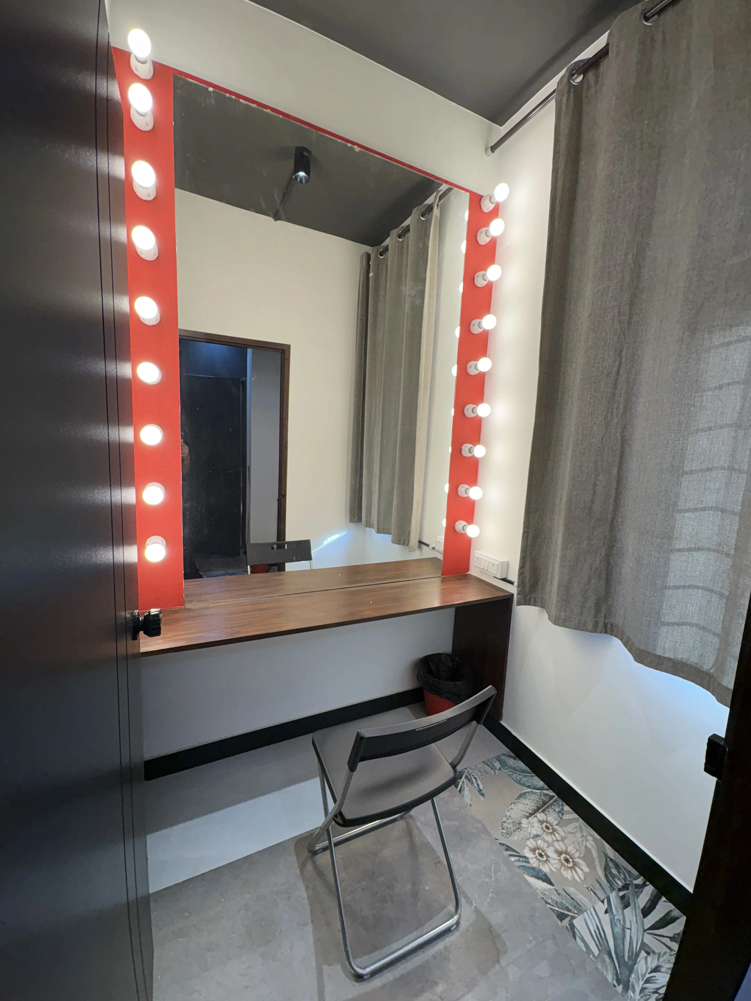 Makeup room with mirror and chair.