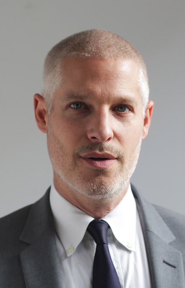 a group of people walking on a sidewalk