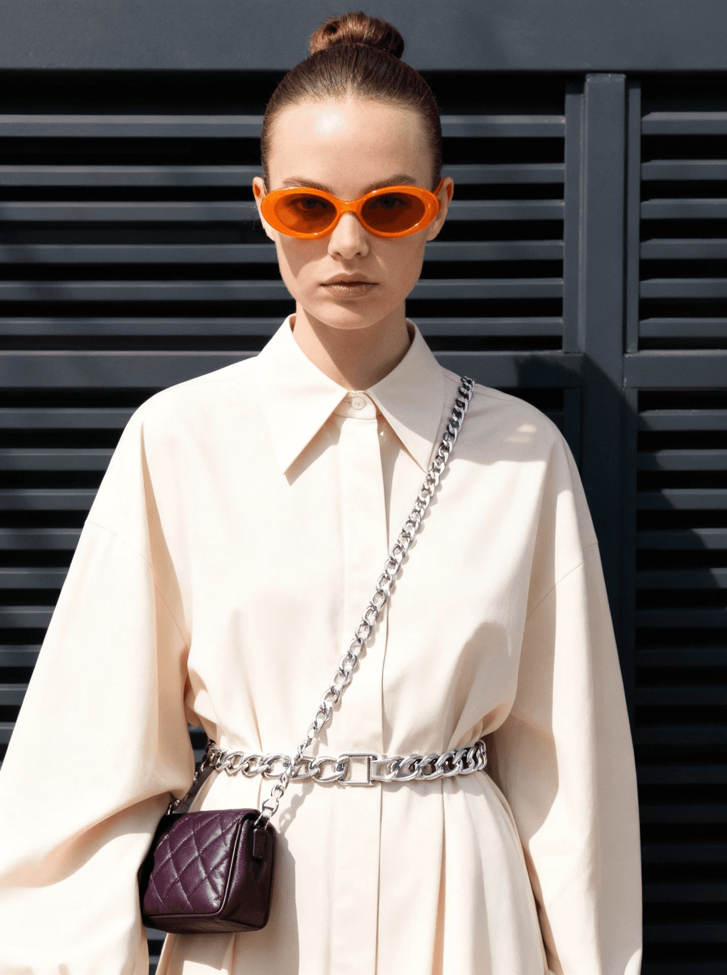 Two people having a pillow fight on a bed