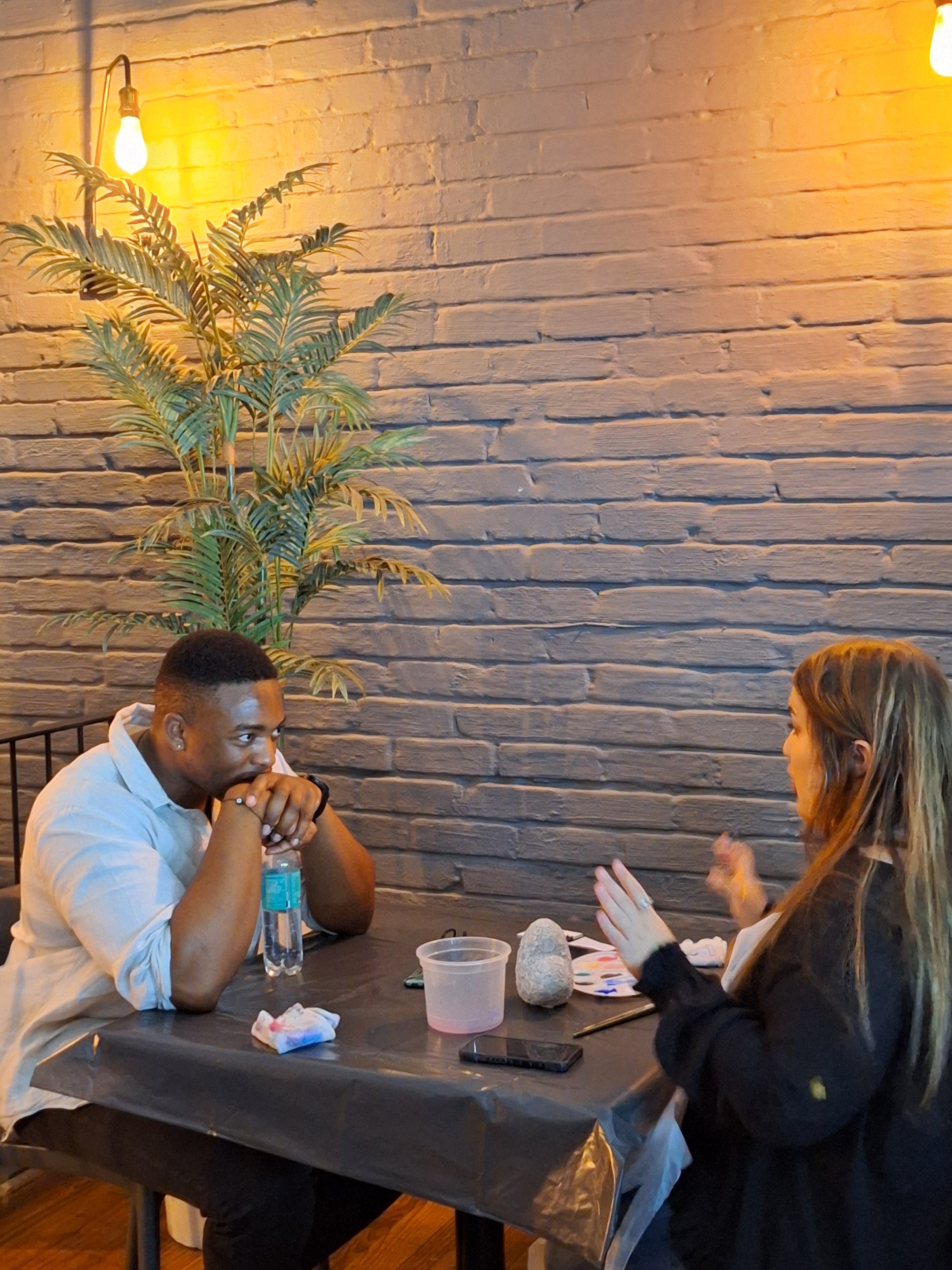 Two people sitting across from each other and talking