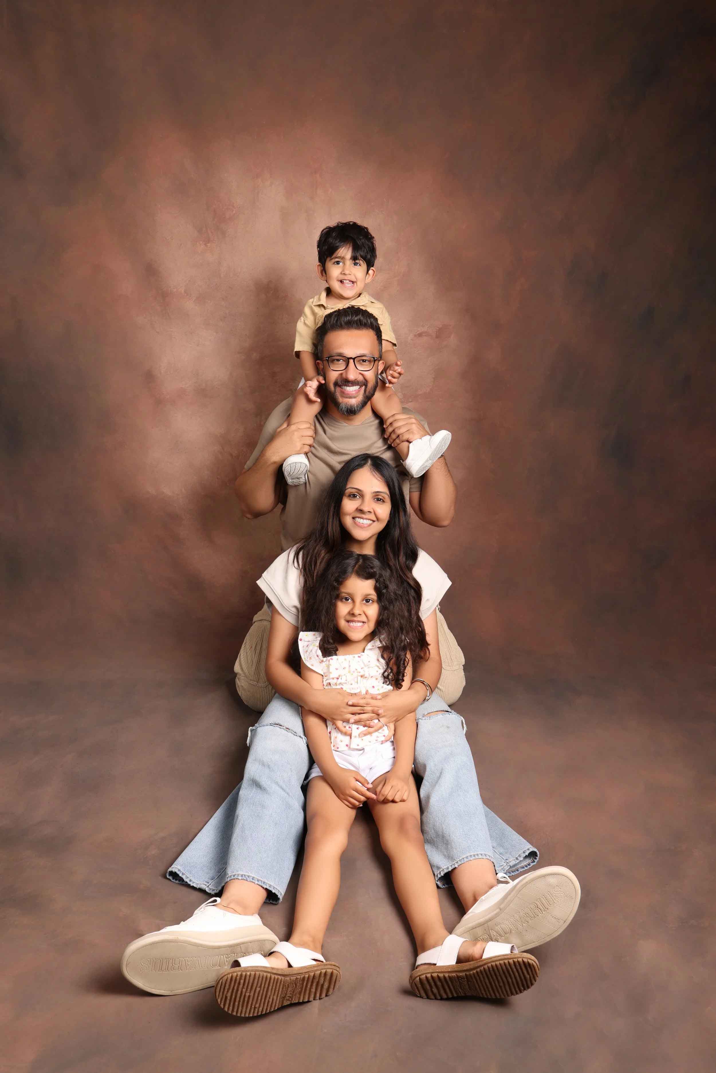Studio family portrait with a parent and two children
