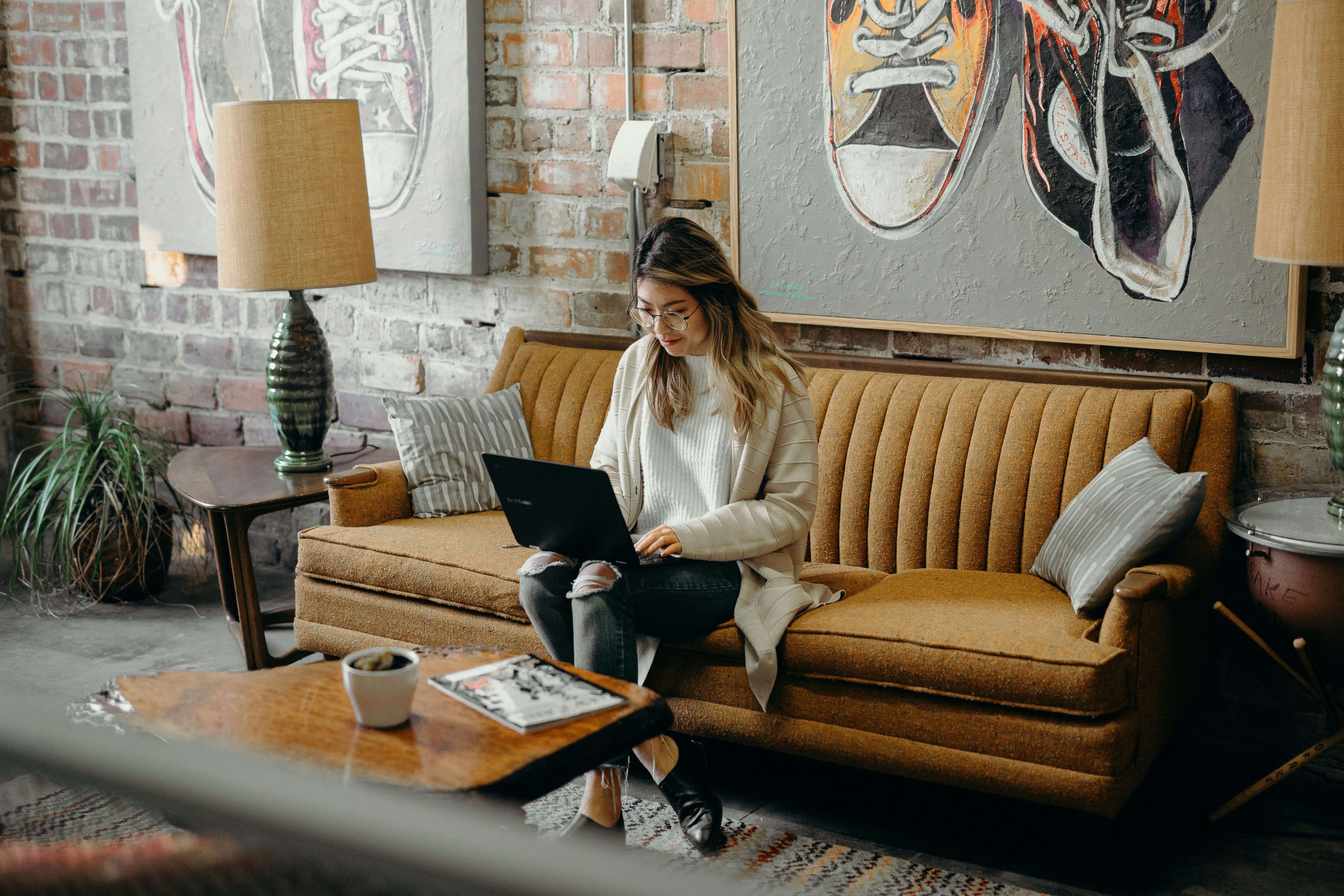 woman working on laptop on couch - Free ChatGPT Alternative For Essays 