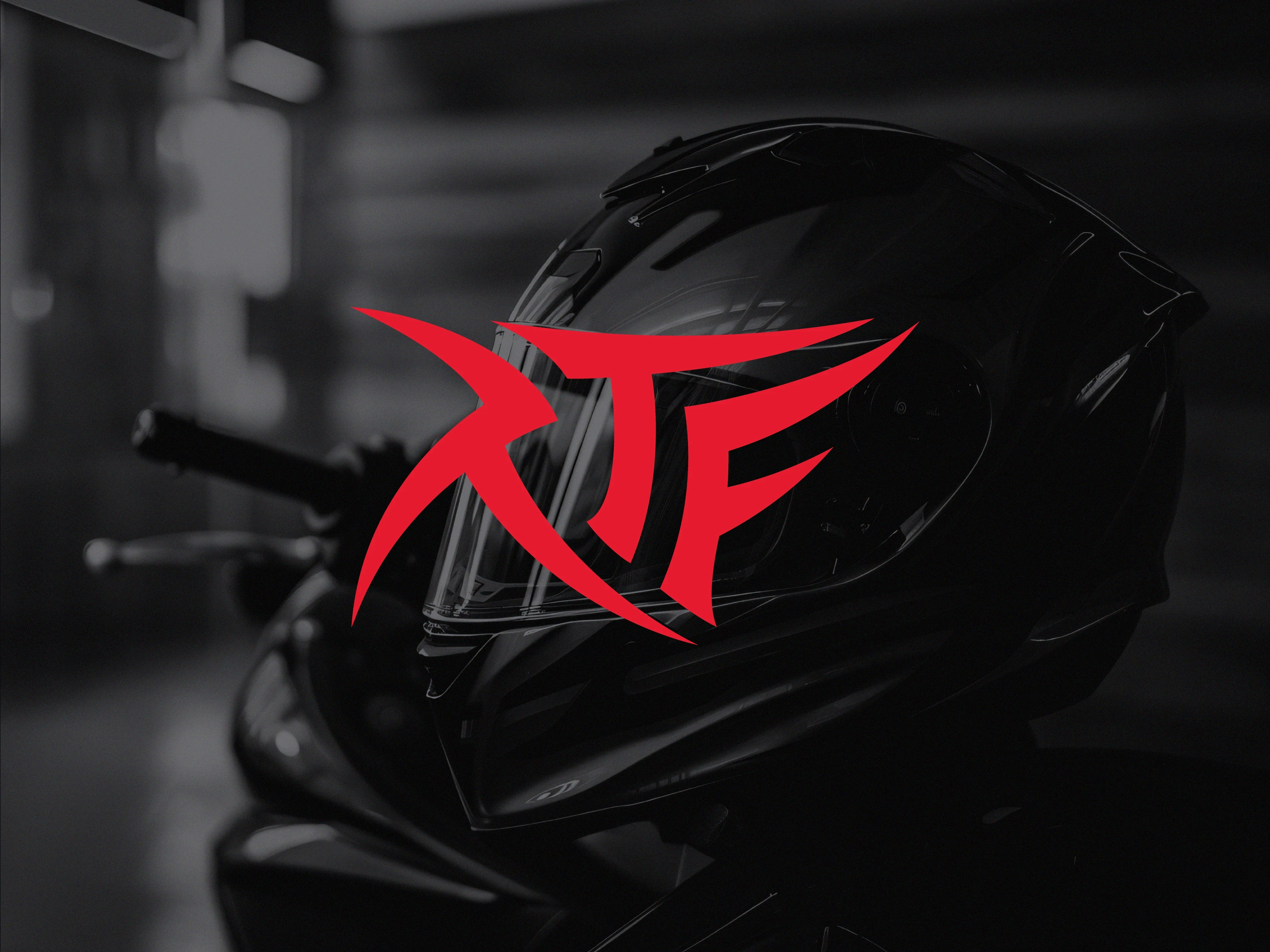 RTF red logo on a black and white image of a helmet rests on a motorcycle