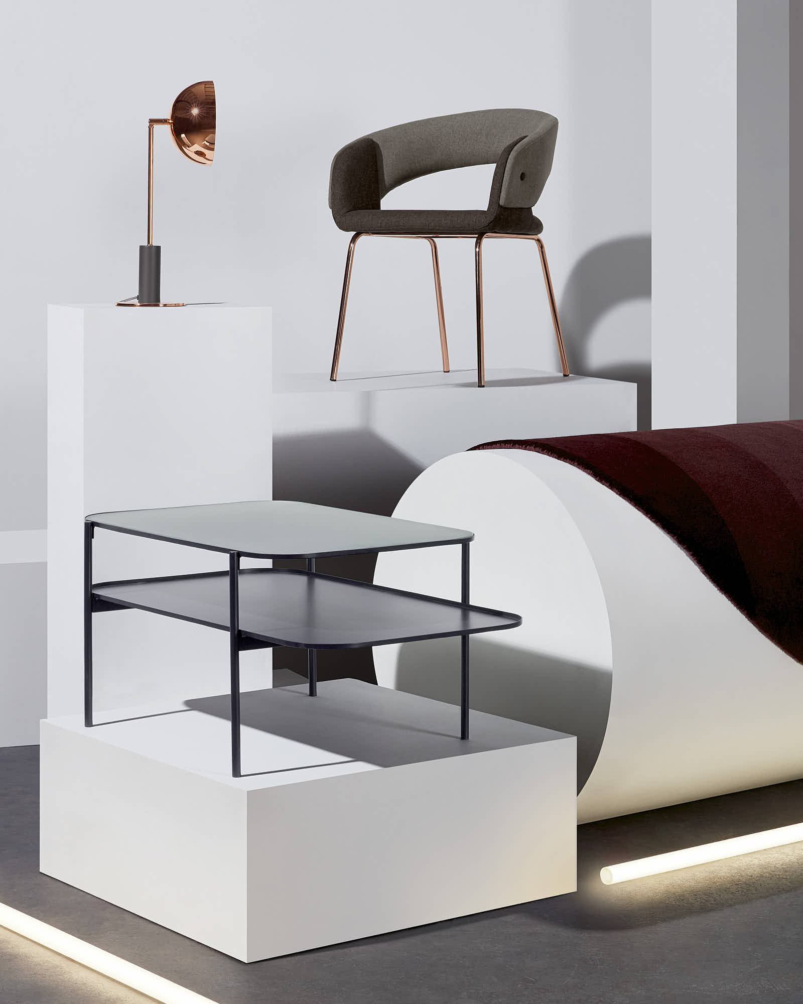 Modern furniture set with chair, table, and lamp on geometric display.