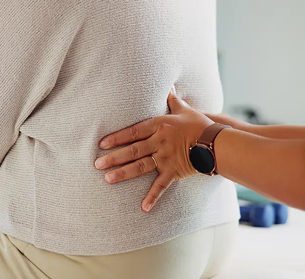 Chiropractor adjusting the lower back of a patient. 