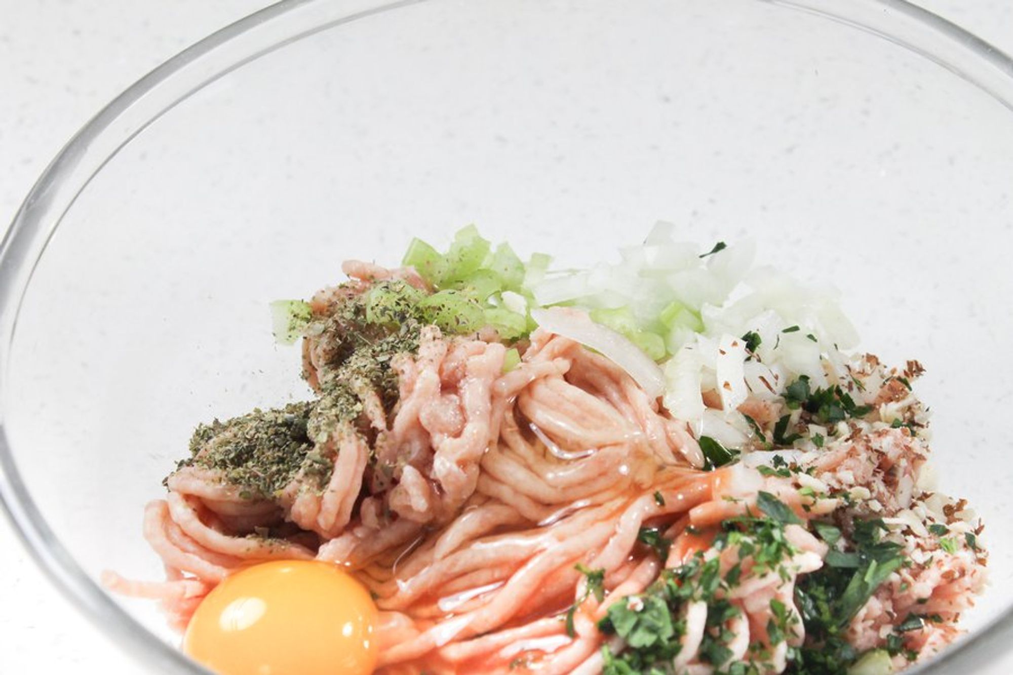 ingredients for buffalo chicken meatballs in a bowl ready to be mixed