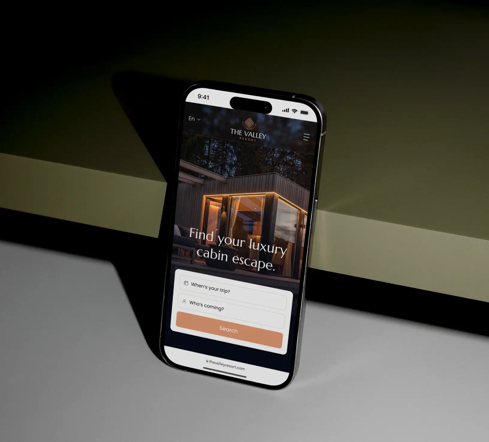 A mobile phone on the wall showing a website interface for real estate