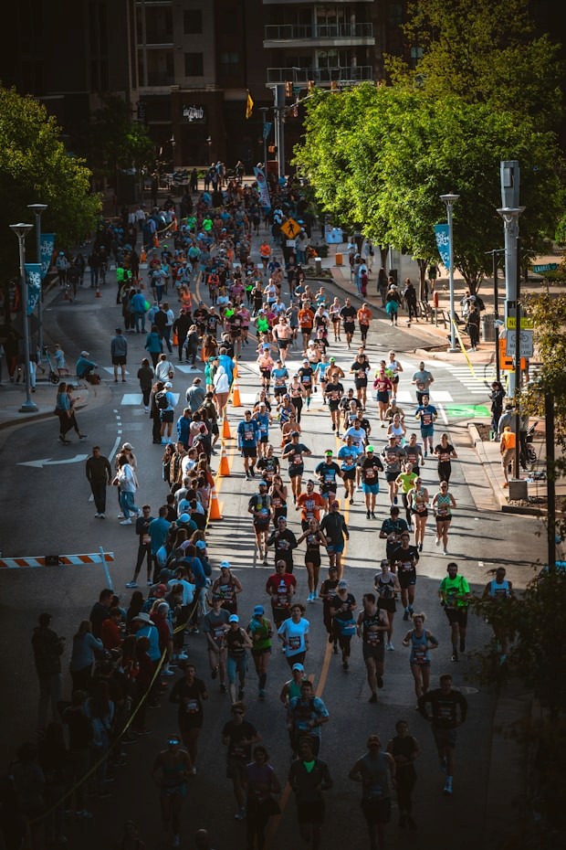 a large group of people running down a street
