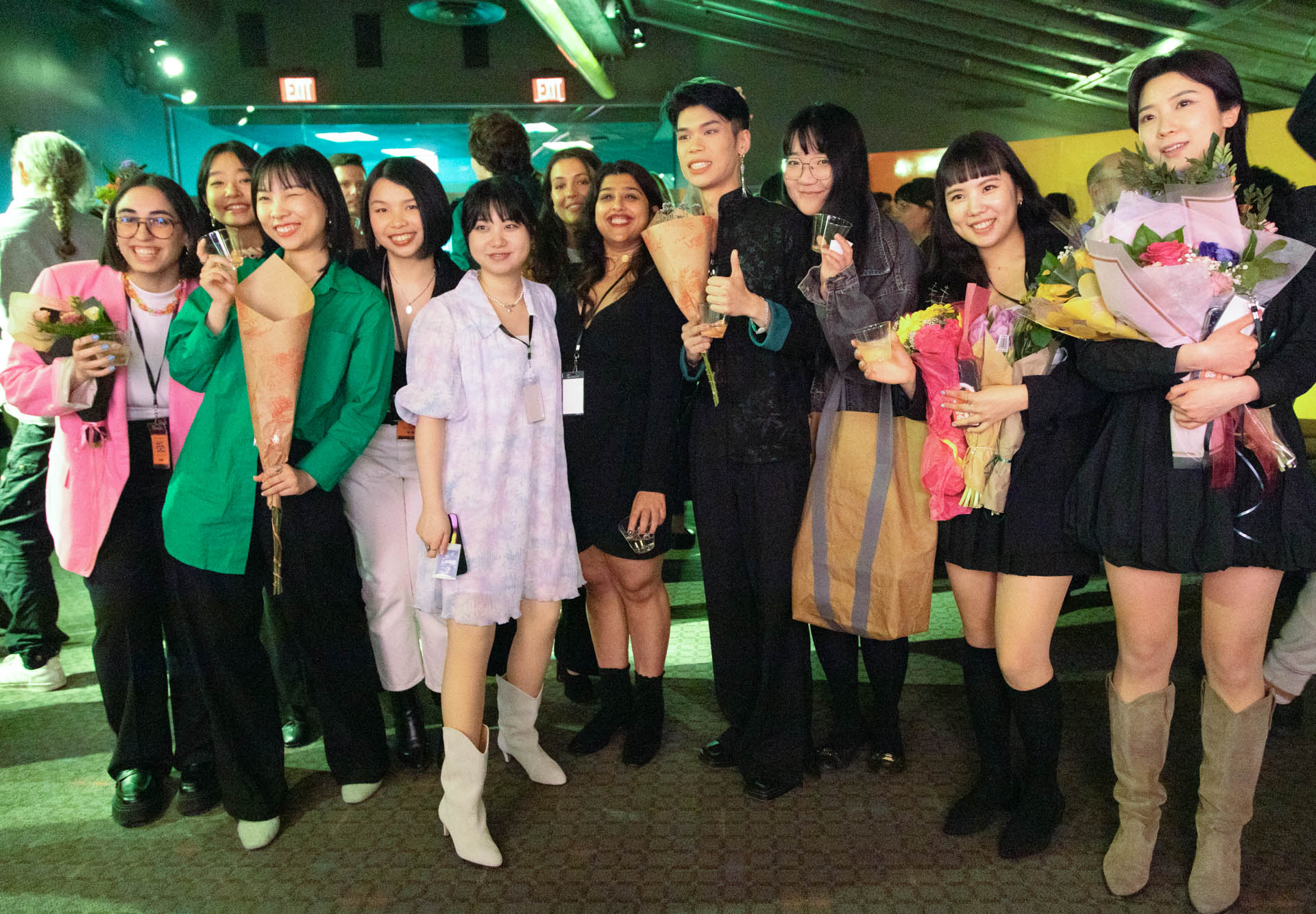 a group of students smiling for the camera in the SVA Theatre lobby after the Venture Forum