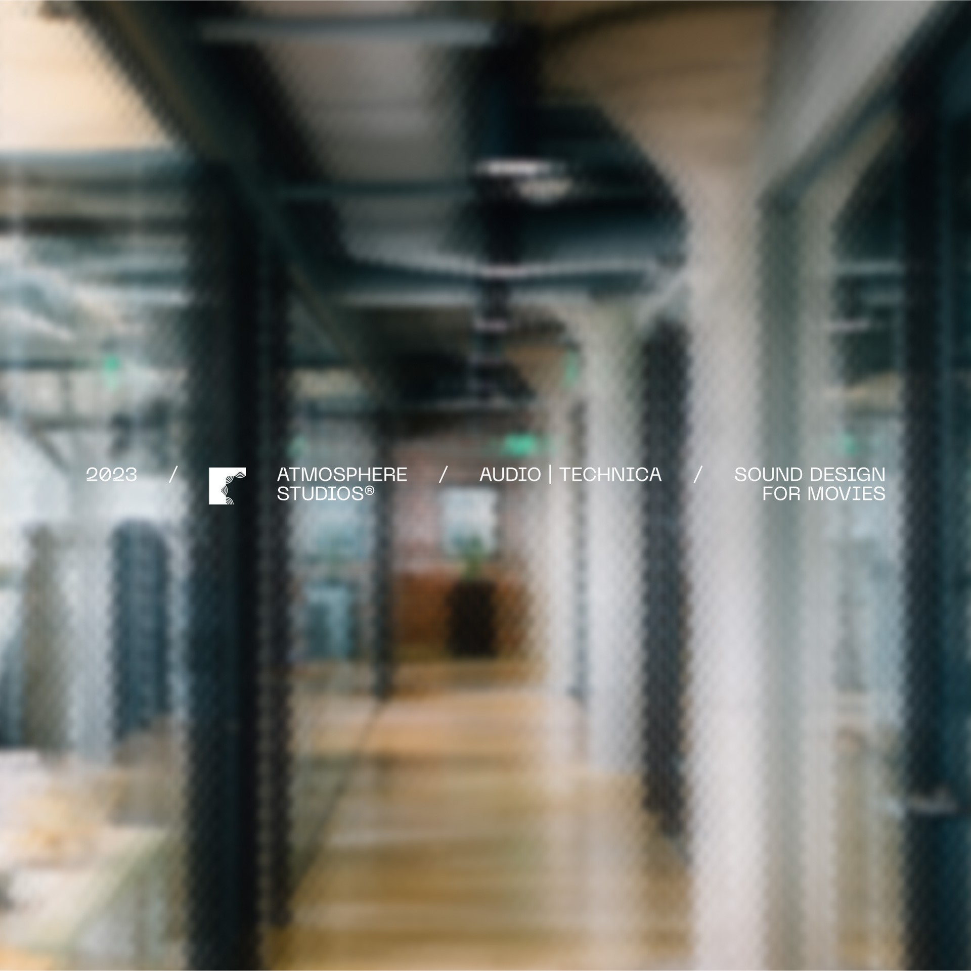 Blurred image of a modern office hallway with glass walls, featuring a text overlay highlighting "Atmosphere Studios," "Audio Technica," and "Sound Design for Movies."