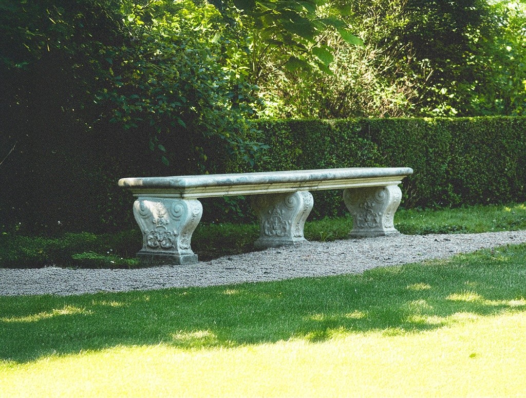 Stone garden bench set within a quiet English garden, representing measured provision and long-term support through trust funds.