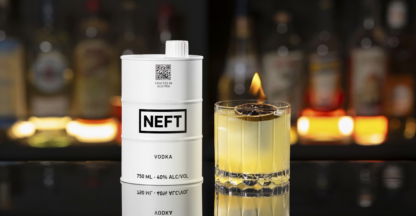 A NEFT Barrel and a glass of My Clementine on a bar counter.