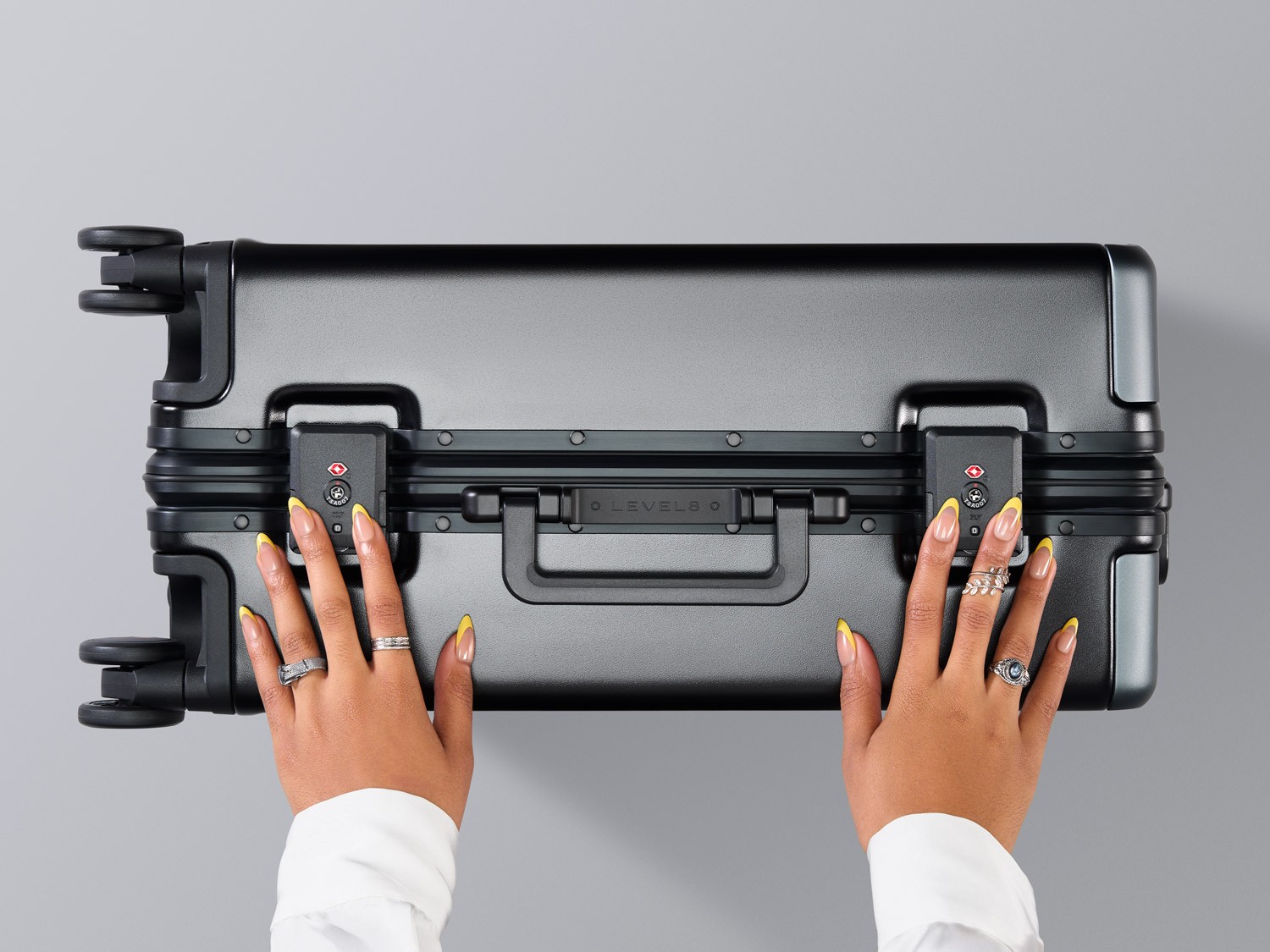 A model closing the Level8 Hegent suitcase photographed by Matthew Brown (London product photographer).