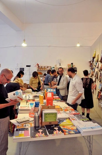 A group of people looking at different books in a library.