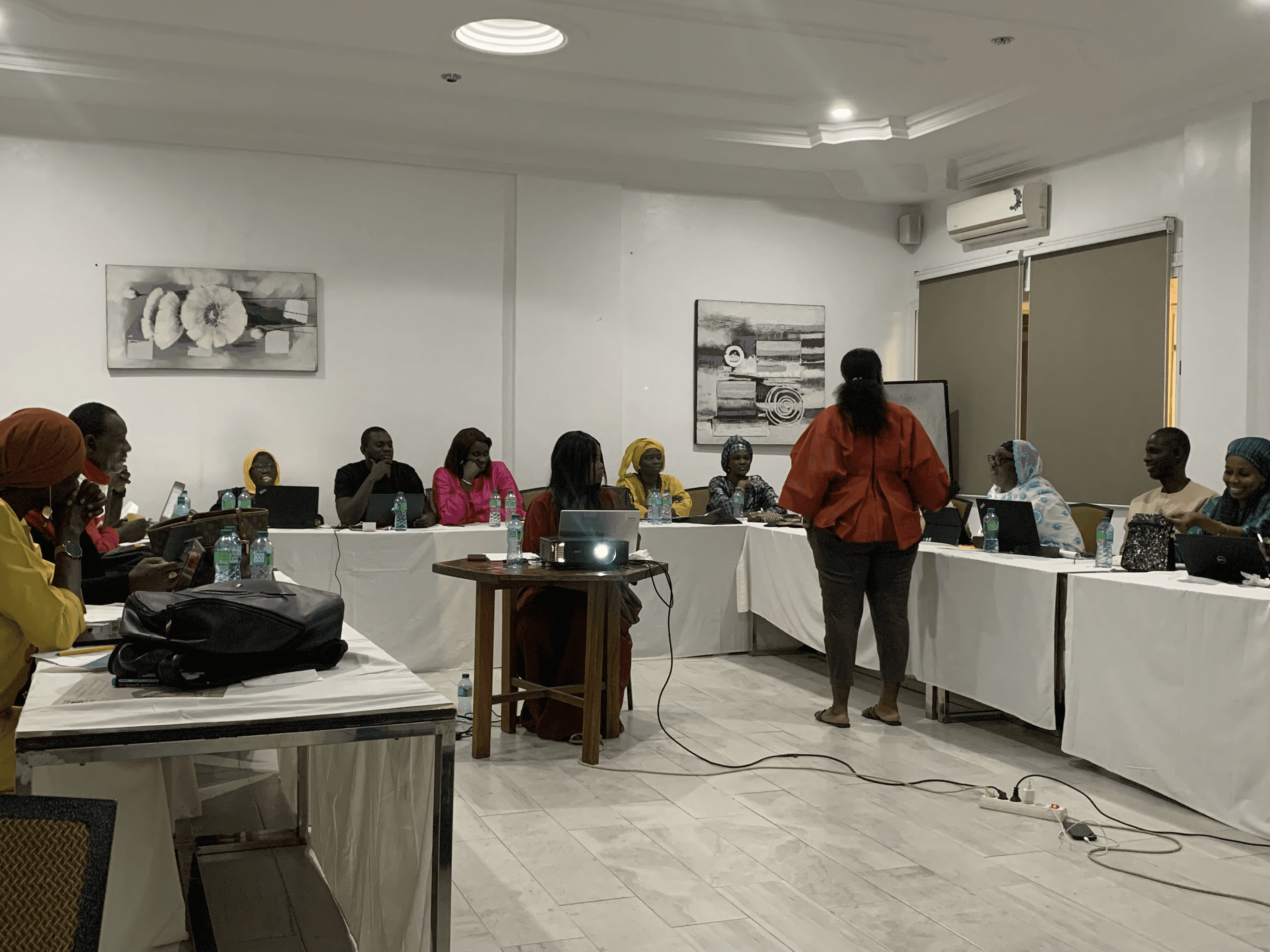 Three children walk along a dirt path.
