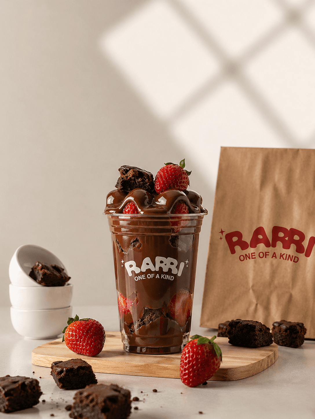 Sculptural chrome vase with a single red flower on white—minimal modern décor still life.