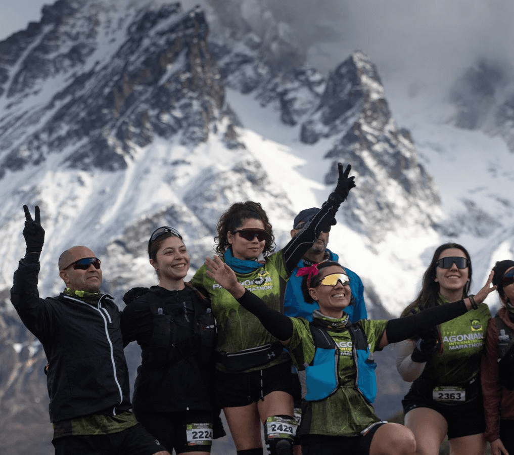 Three people sitting on a couch in a room looking at mobile devices