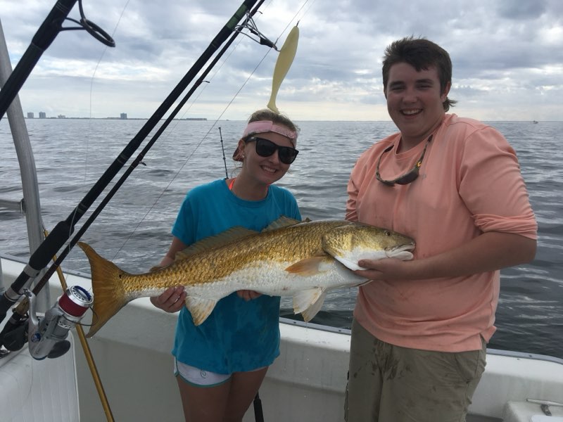 Couple holding a Redfish