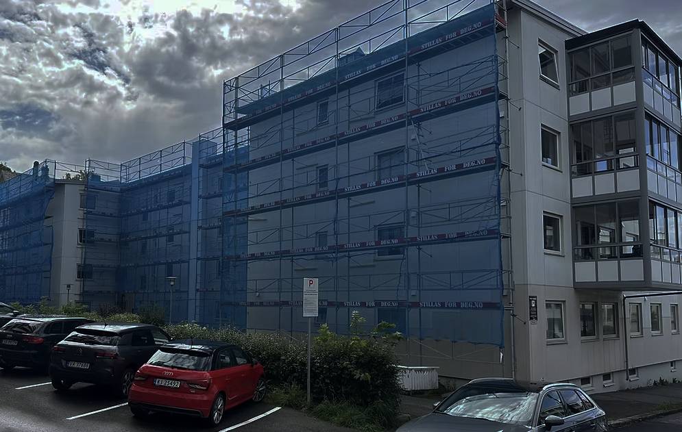 a man working on a roof with a power drill