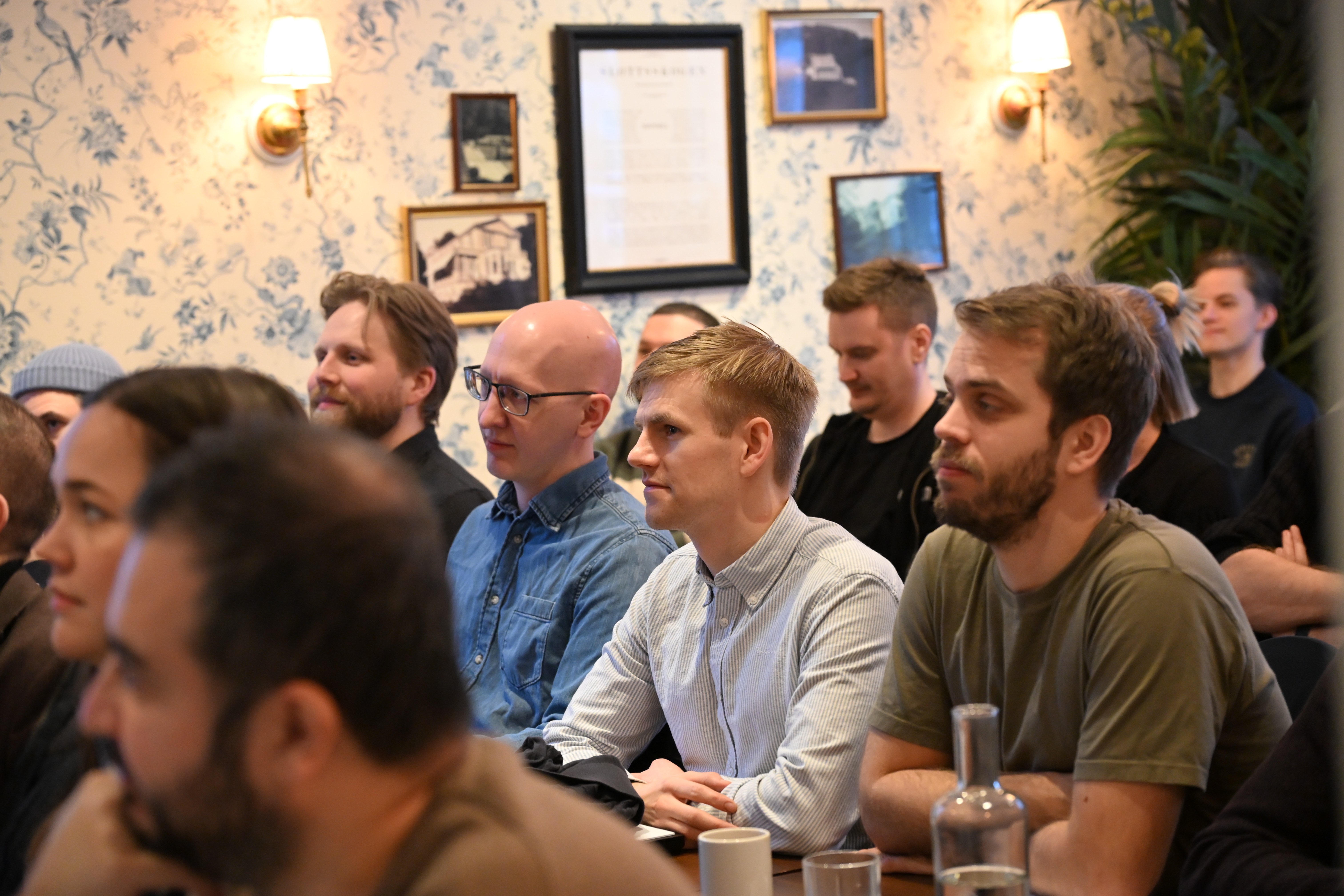 Laptop, tablet, and phone on a wooden desk.