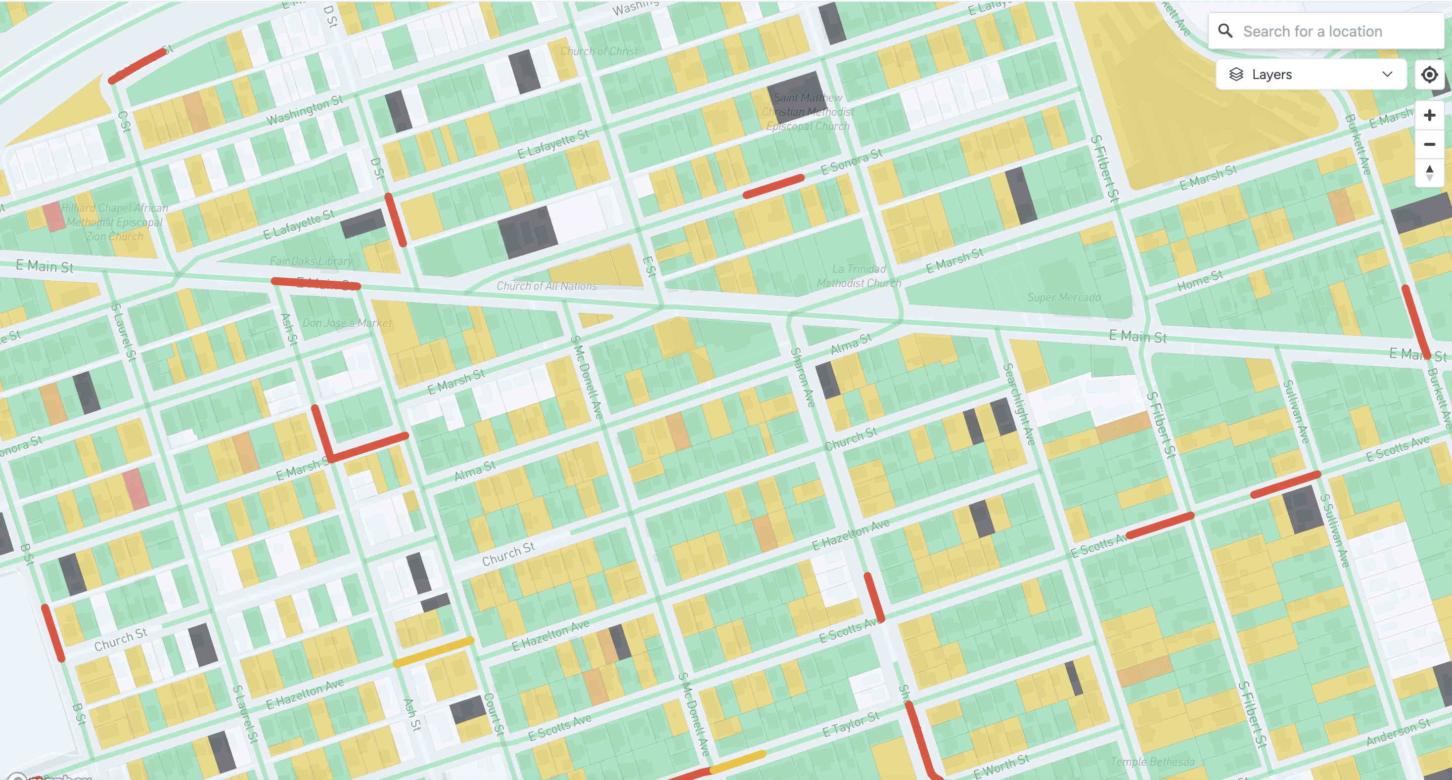 Detailed map of city blocks with various building colors, streets, and road markings. The buildings are green, and yellow.