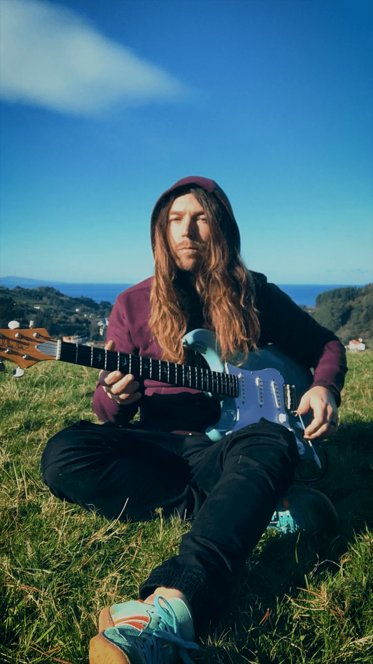 People playing soccer on a rooftop court surrounded by city buildings