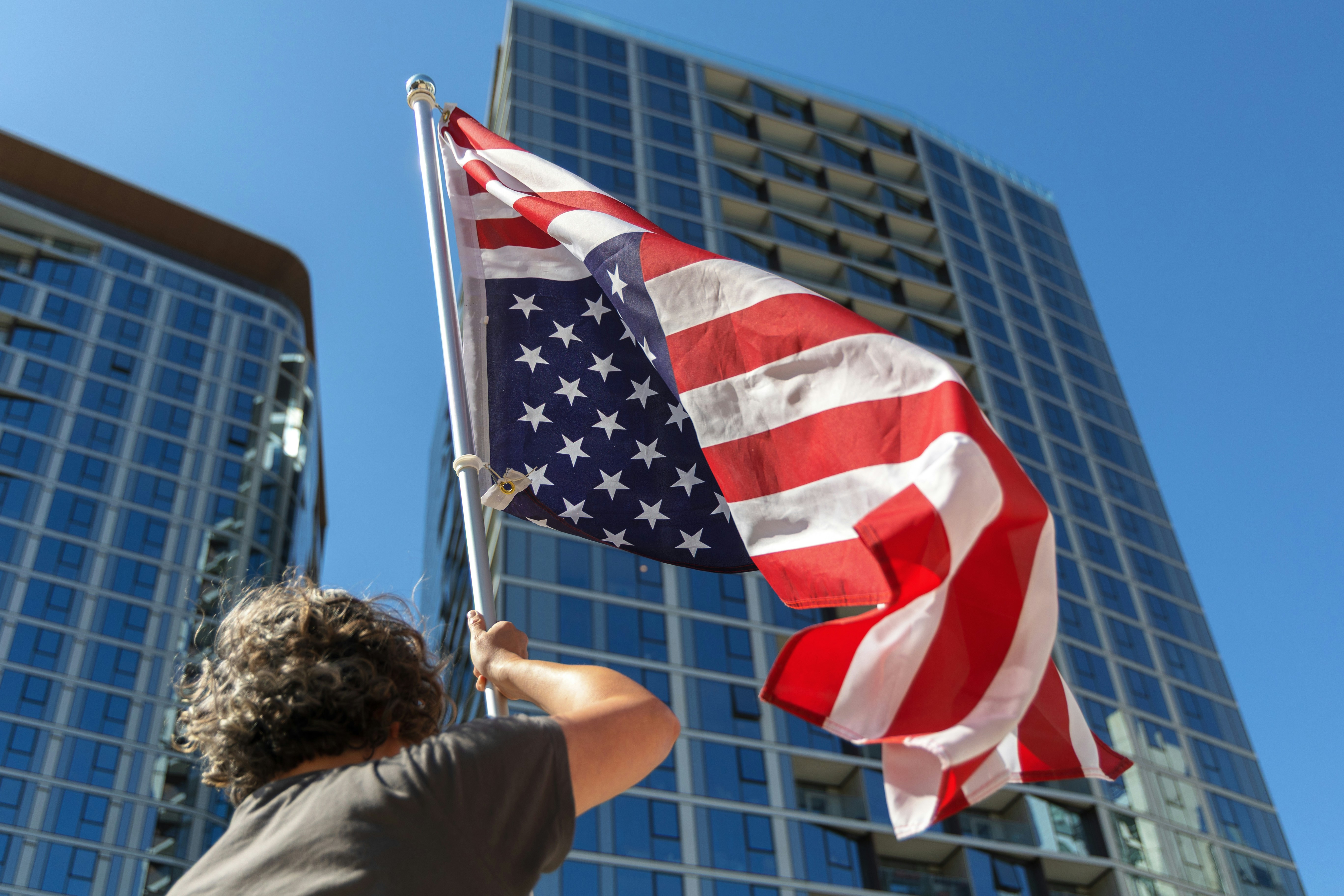 A person waves the american flag proudly.